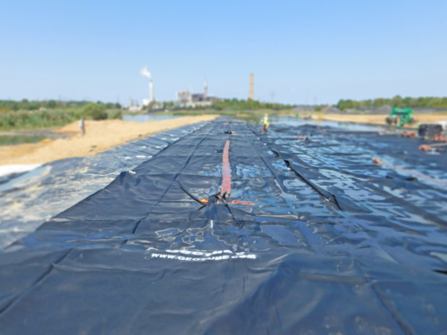 Geotextile tube, deployed, plumbed and ready to be filled with coal ash