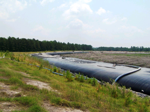 Geotextile tube installed around the corner of the ash pond